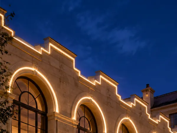 LC-NT slim top bend silicone neon flex tracing a window arch and stepped parapet at night