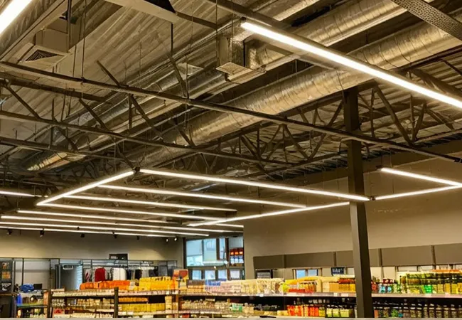 TRON-WV 0-10V linear track light over shop clothing aisle