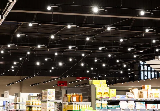 VUE-3 3-wire DIP track lights over chain store aisle