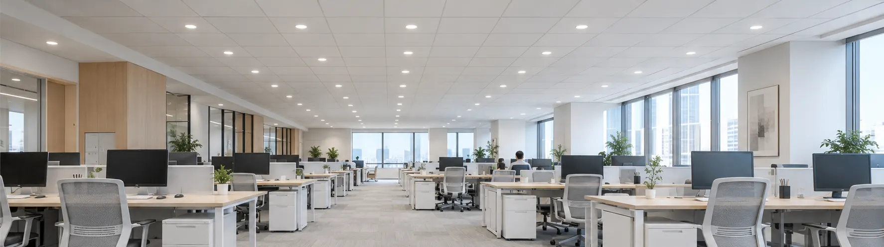 White PURE-S DL02 downlights laid in a regular office ceiling grid with uniform spacing