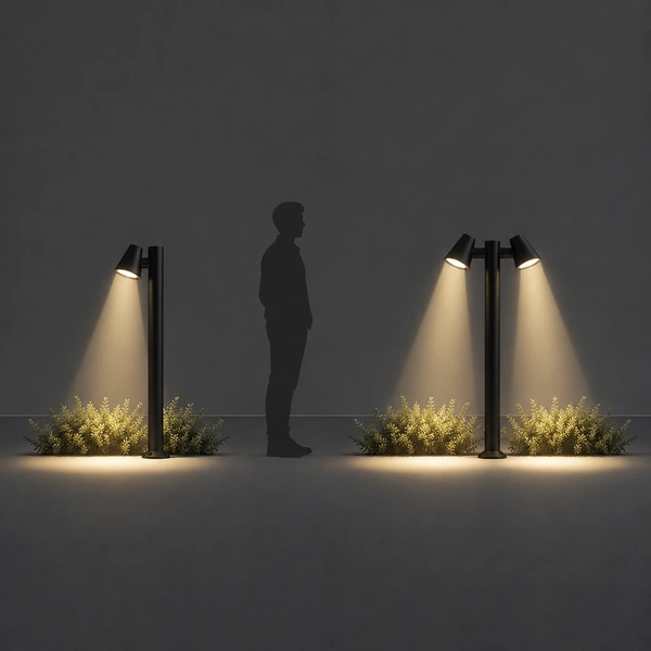 Sand Black BAM SER directional spot bollards aiming warm beams at entrance drive planting
