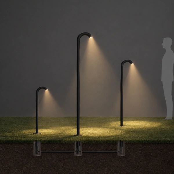 Black GOOS-S swan-neck poles casting soft pools over a night path and planting