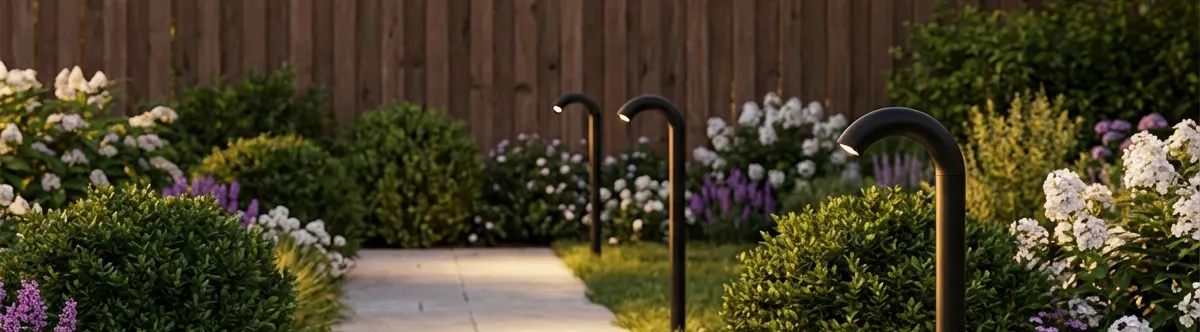 Black gooseneck path lights along a landscaped garden walkway